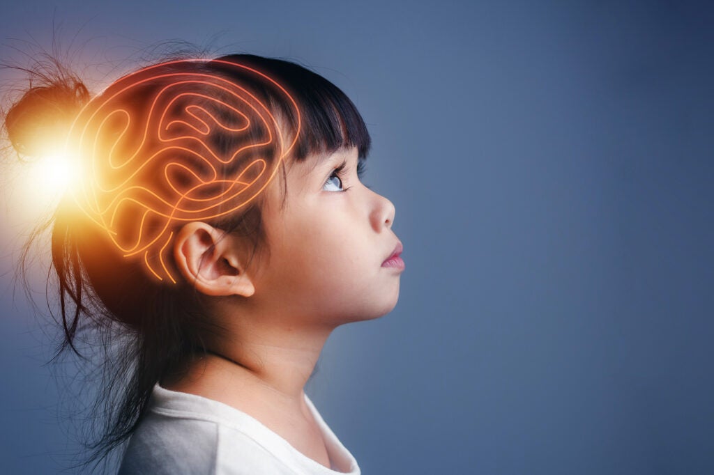 A photoillustration of a child with their brain highlighted to represent innovation