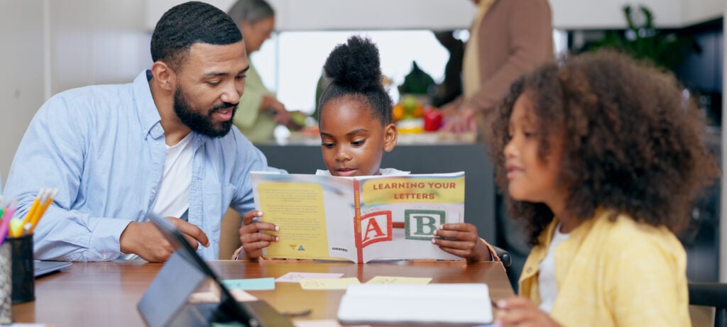 Father, kids and book for teaching, reading and tablet with support for education, development or studying at desk. Dad, children and help with language, online course and home school in family house